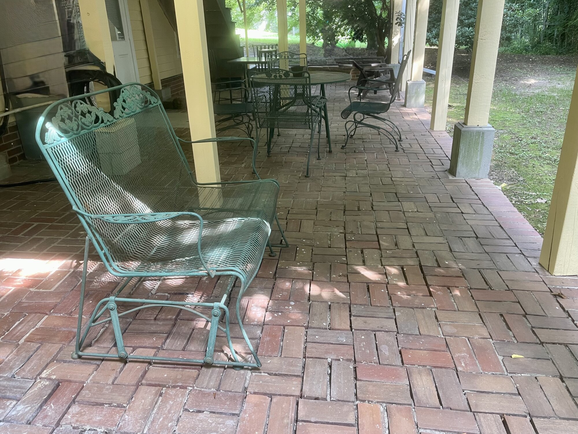 Covered back patio with wrought iron furniture viewed from the 1023 side
