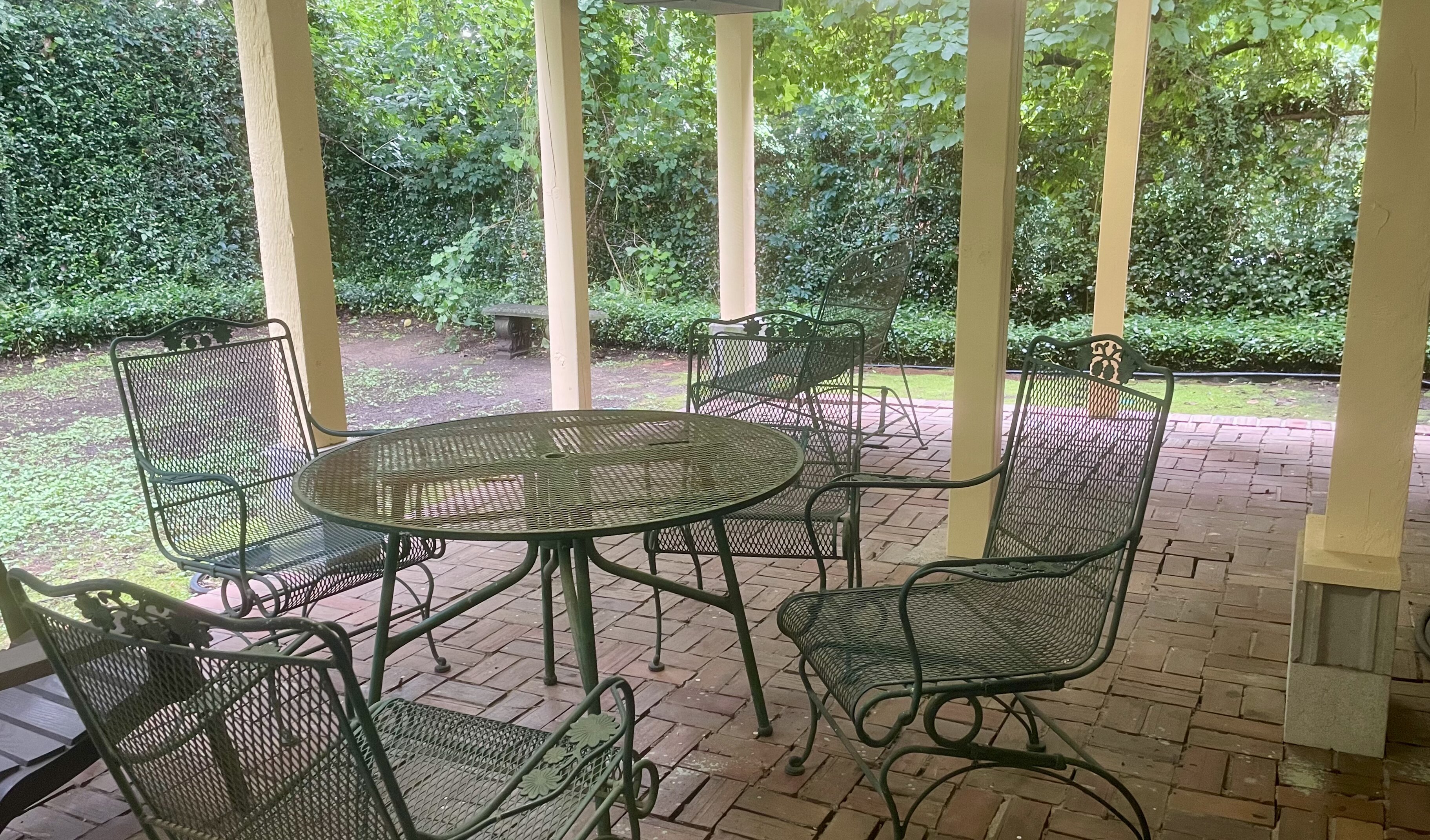 Covered back patio with wrought iron furniture for tenant use