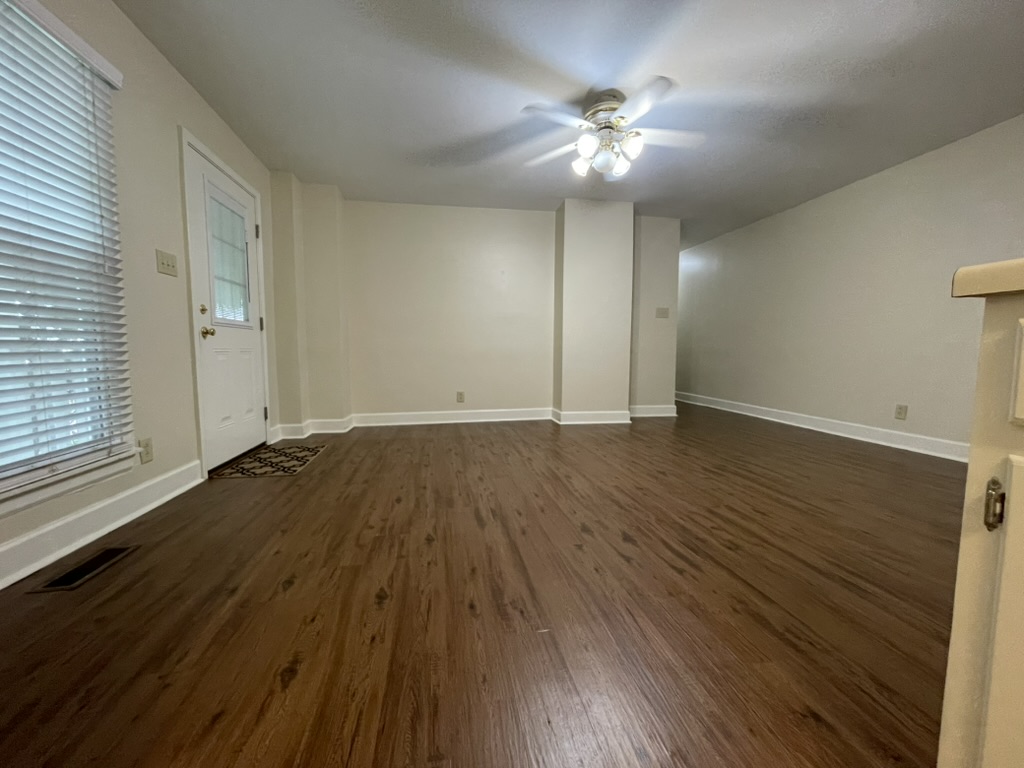 Living room from kitchen showing front door and hallway